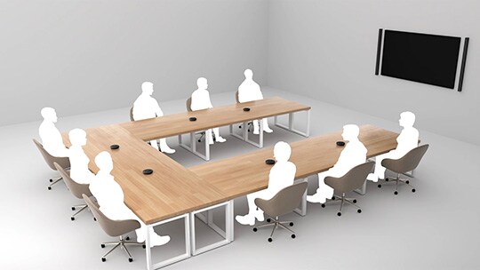 Illustration showing nine person having meeting in a room with long tables arranged in a U-shape